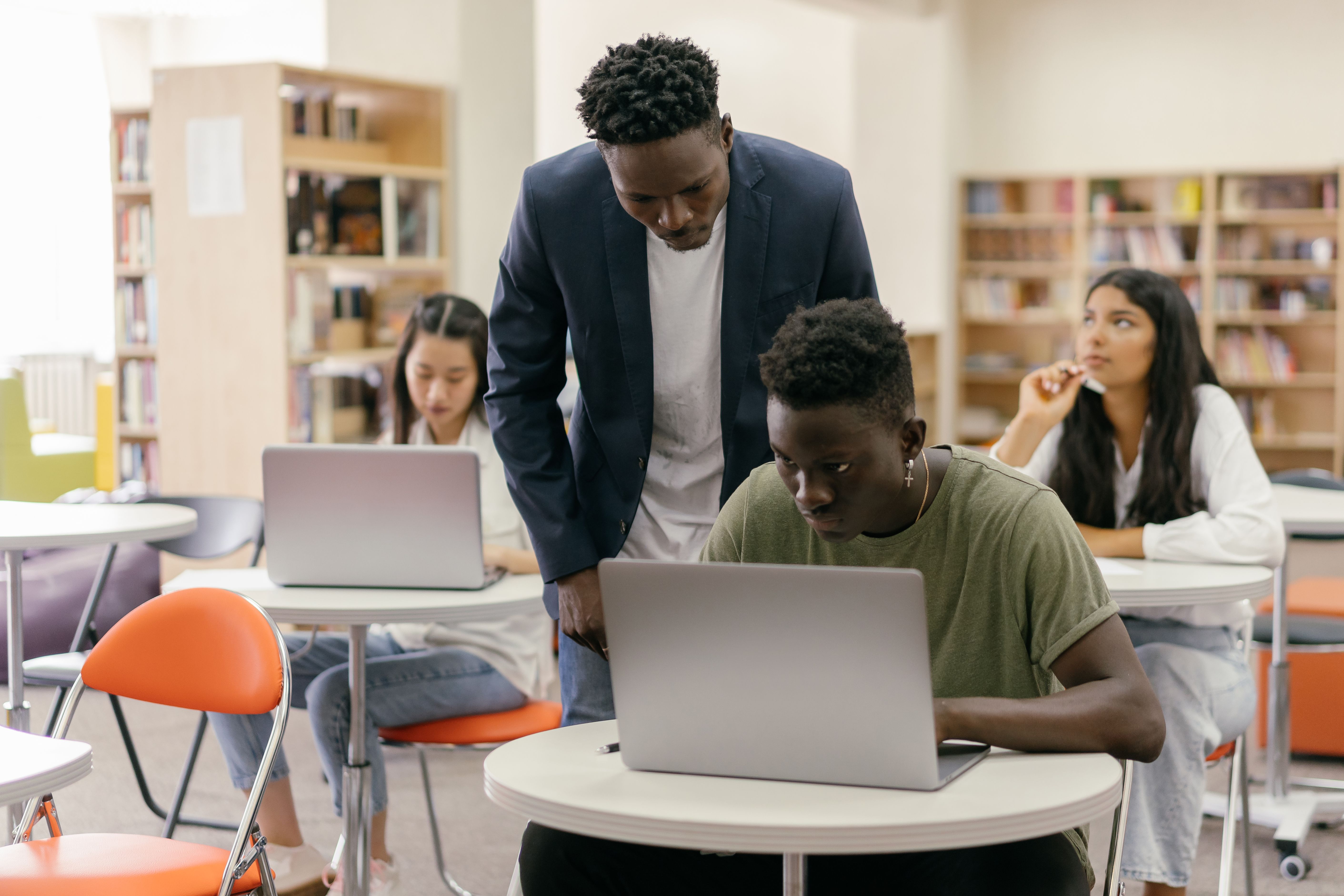 Professionally dressed students learning with laptops in a technology classroom